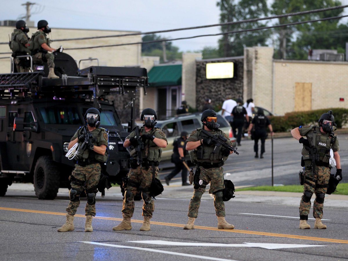 Police Reaction to Peaceful Protests in Ferguson, MO. after white Police Officer shots and kills Black boy, 12 times.