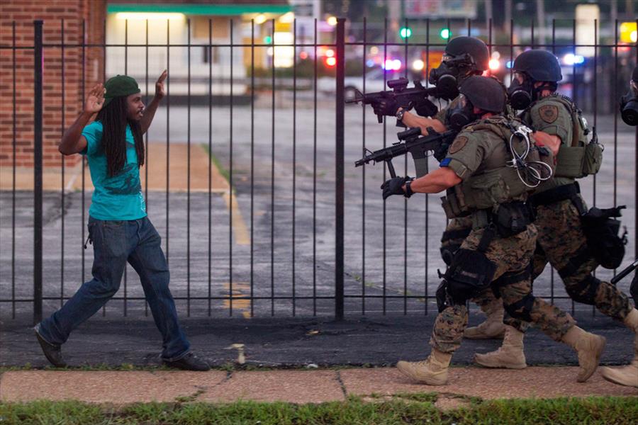 Ferguson white cops charge at an innocent Black man during peaceful protests in memory of Michael Brown who was murdered by a white cop.