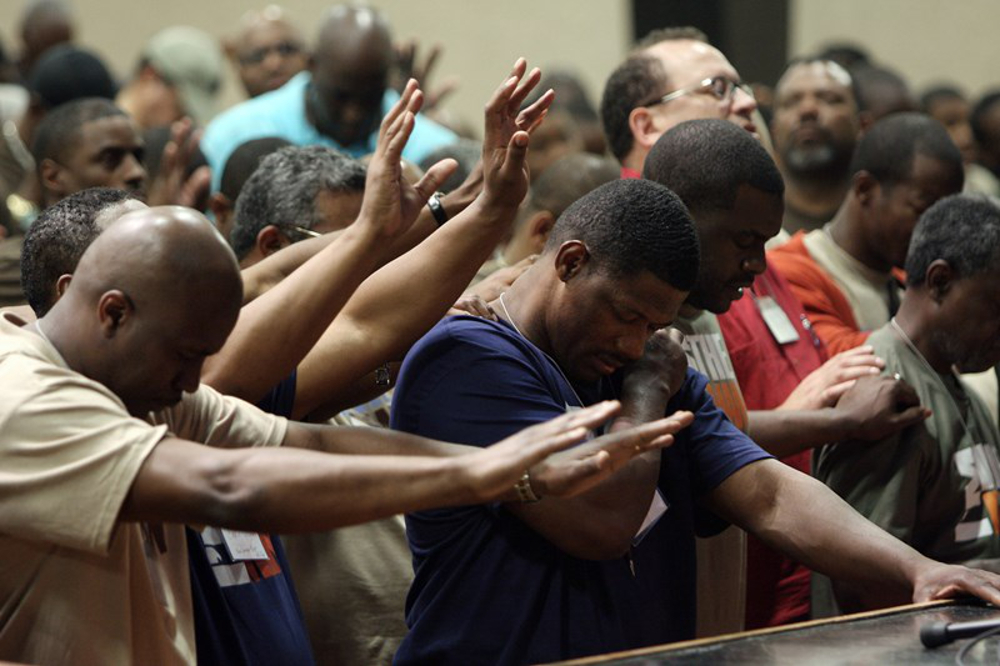 Black men worship during a church service.