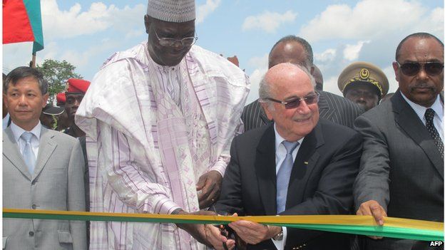 Sepp Blatter - here with Cameroon's sports minister - has overseen massive investment in facilities in Africa.