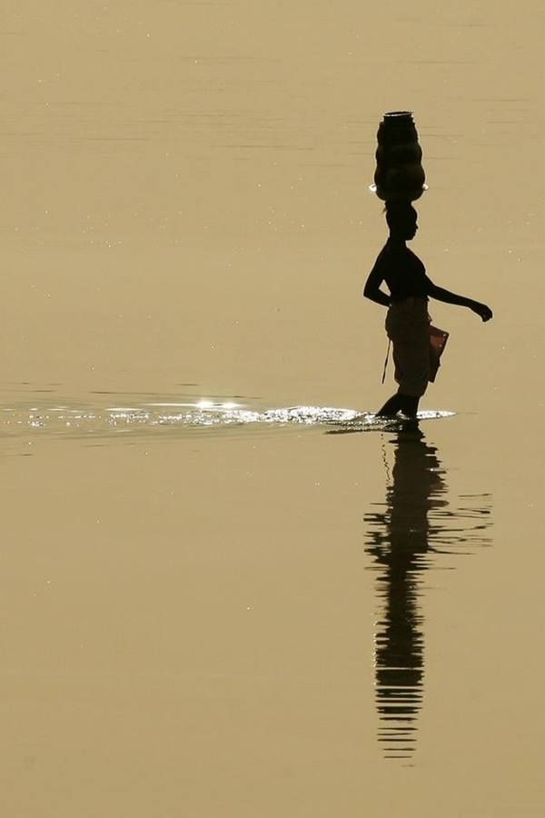 Image: A woman who knows what she wants crossing the river on foot to get it.