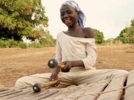 Image: A girl playing the Xylophone. Tamale, Ghana