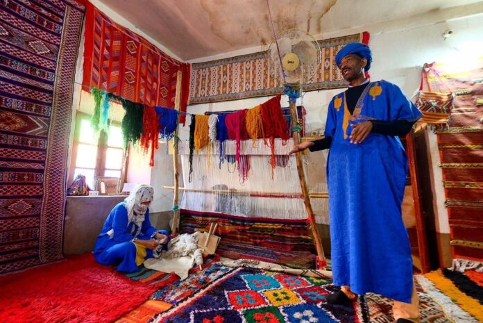 Berber man, North Africa, showcasing the traditional Berber carpets.